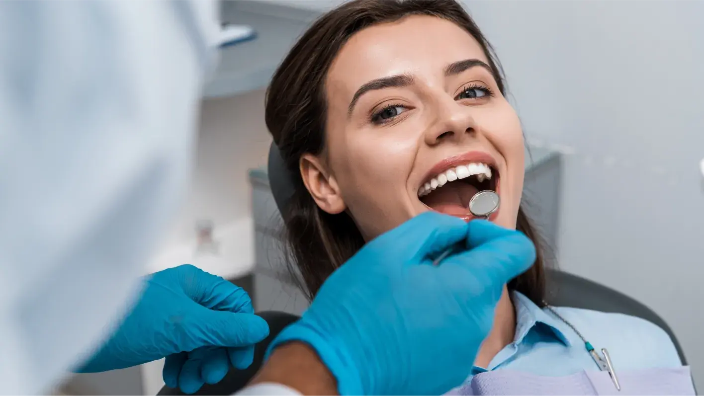 Woman with white teeth at dentist getting a checkup
