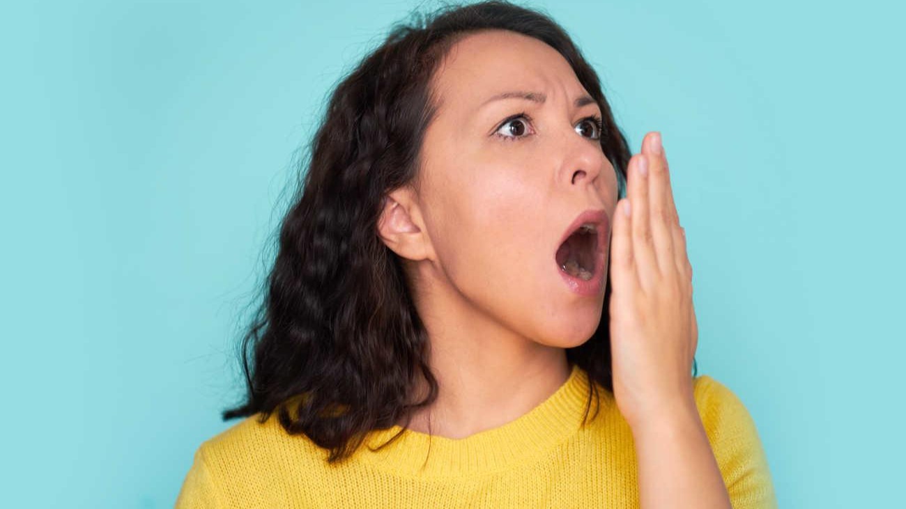 Woman checking for bad breath