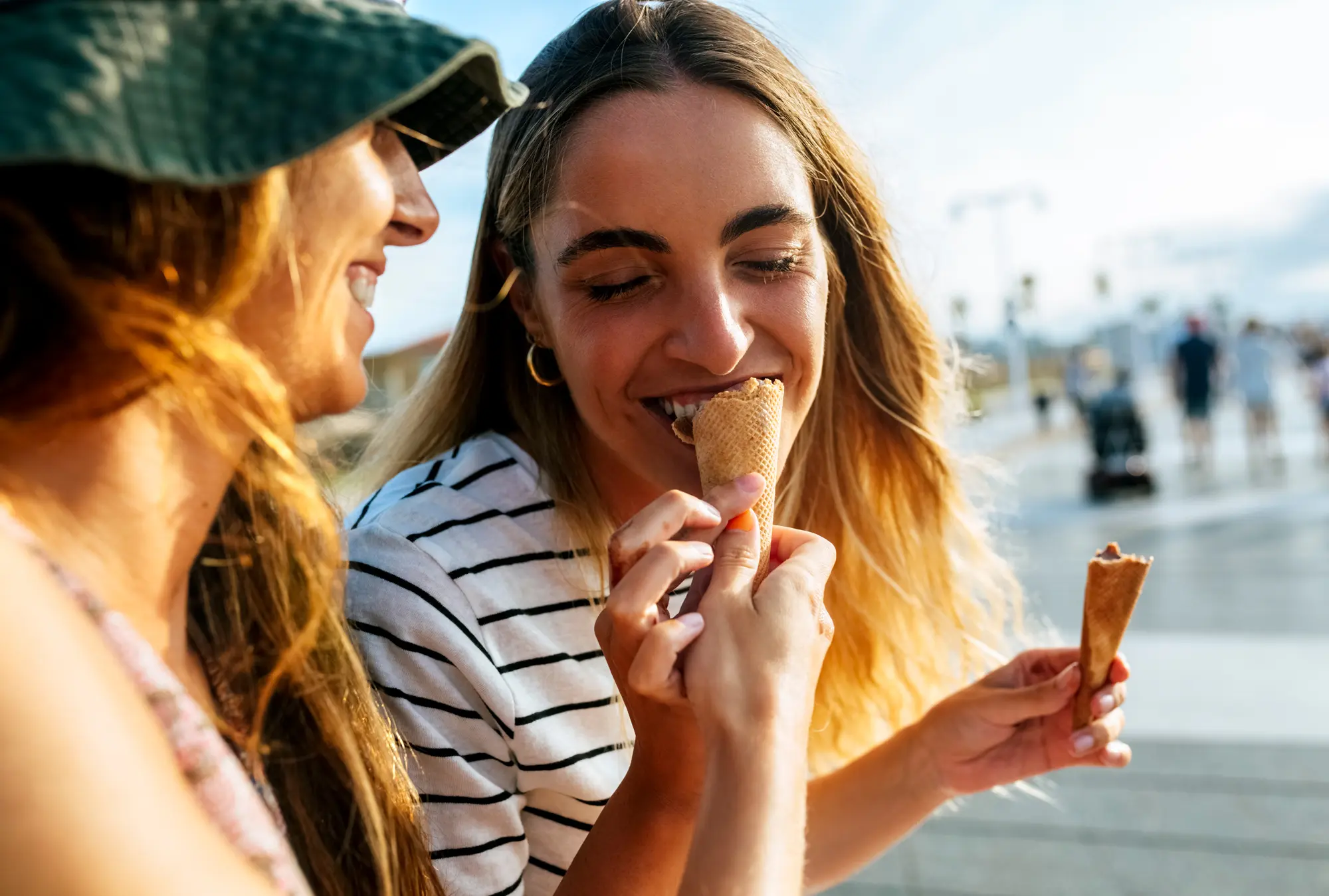 Woman smiling and eating an ice cream