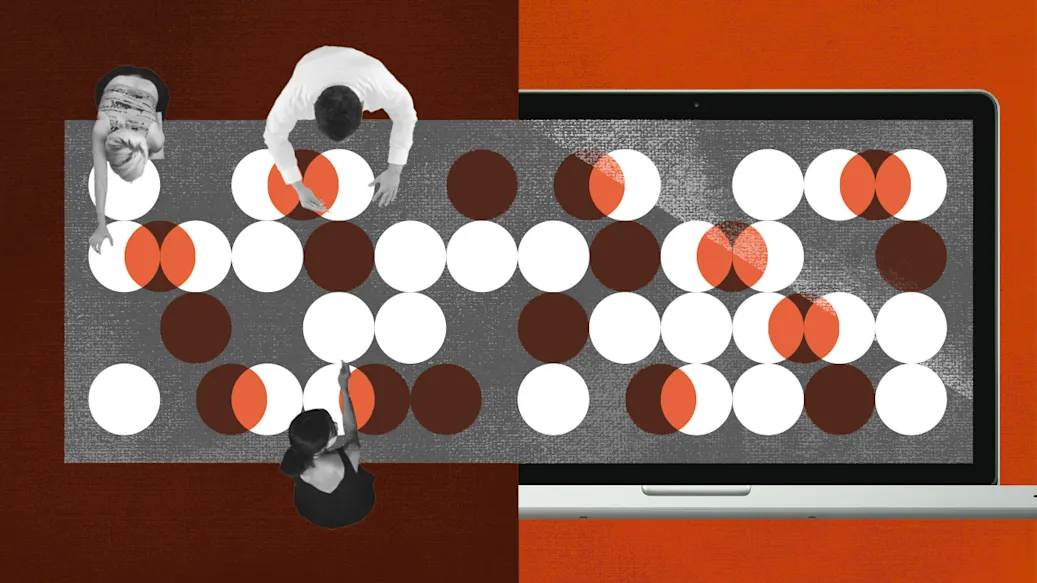 Version two of an overhead view of three people working on a project laid out on a large conference table.