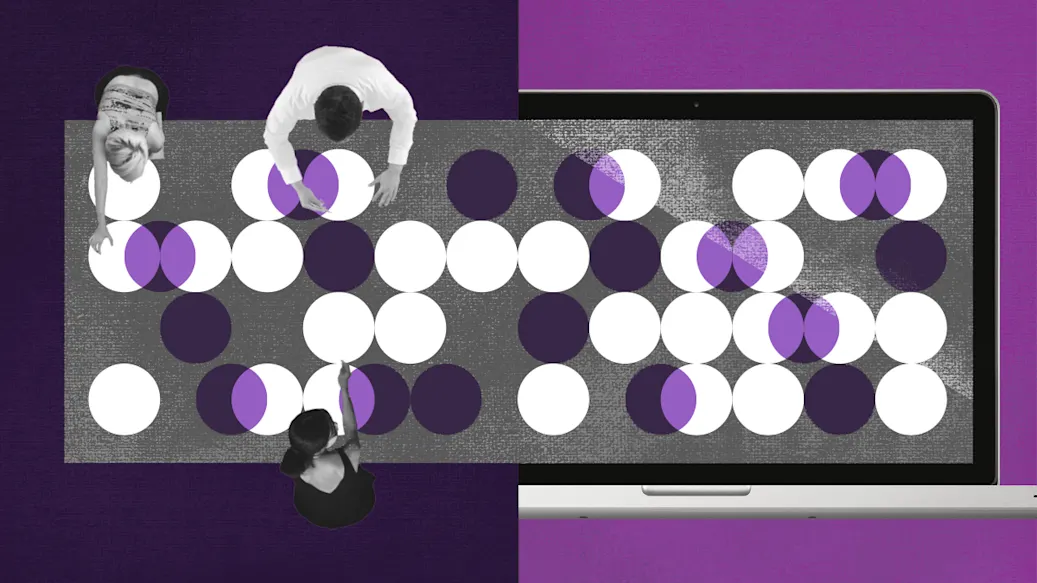 Overhead view of workers sorting items at a large conference table.