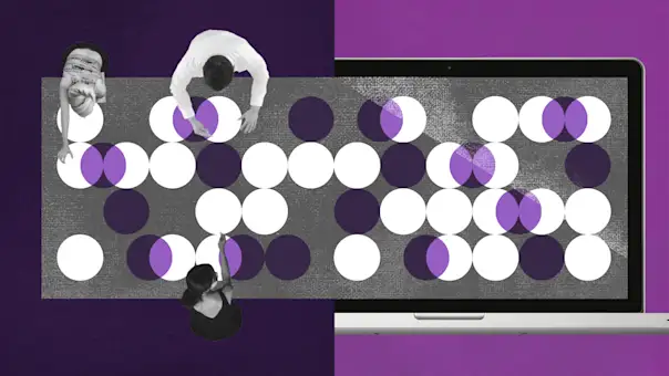 Overhead view of workers sorting items at a large conference table.