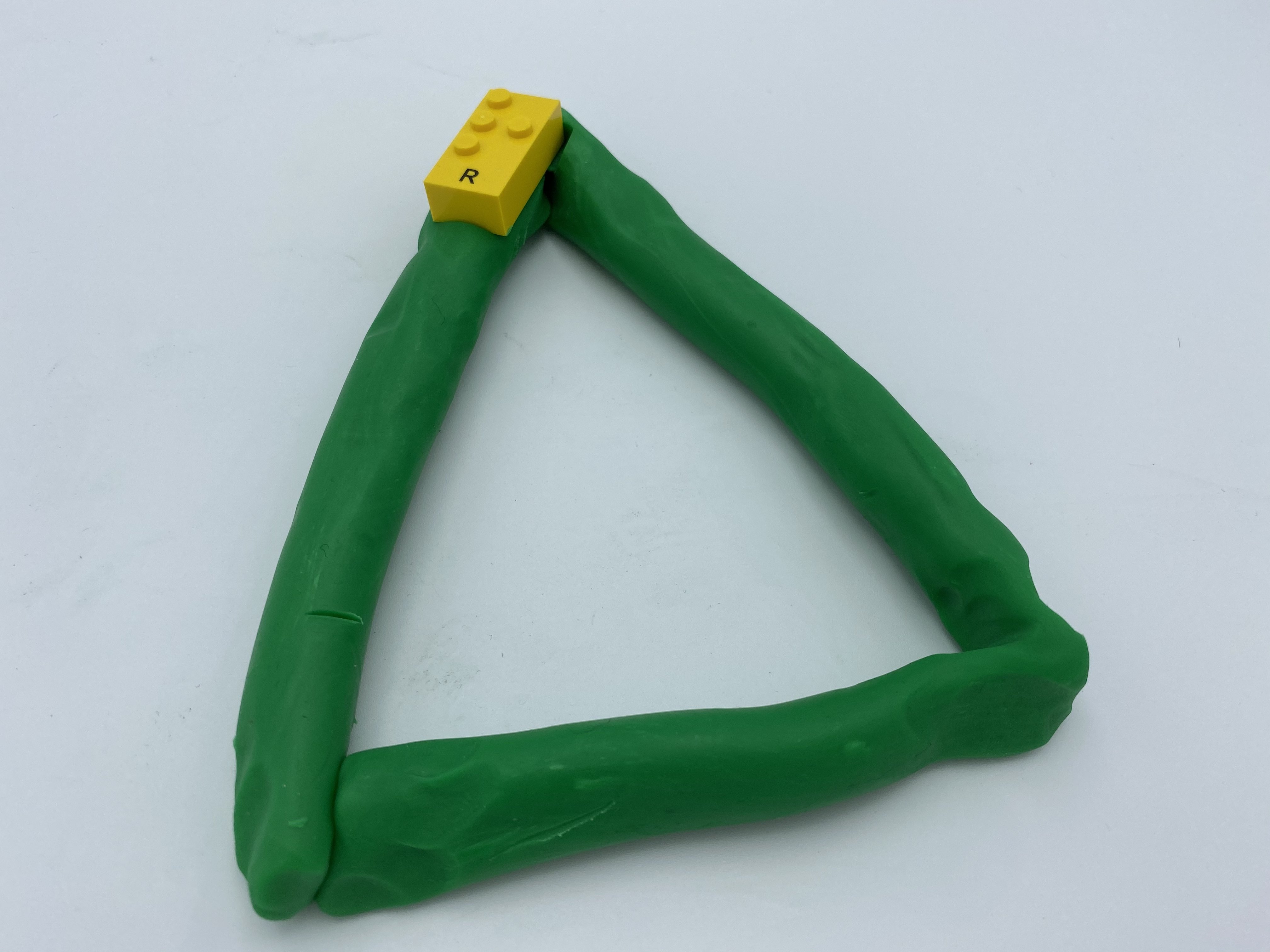 A triangle shape of Playdough with a LBB on it.