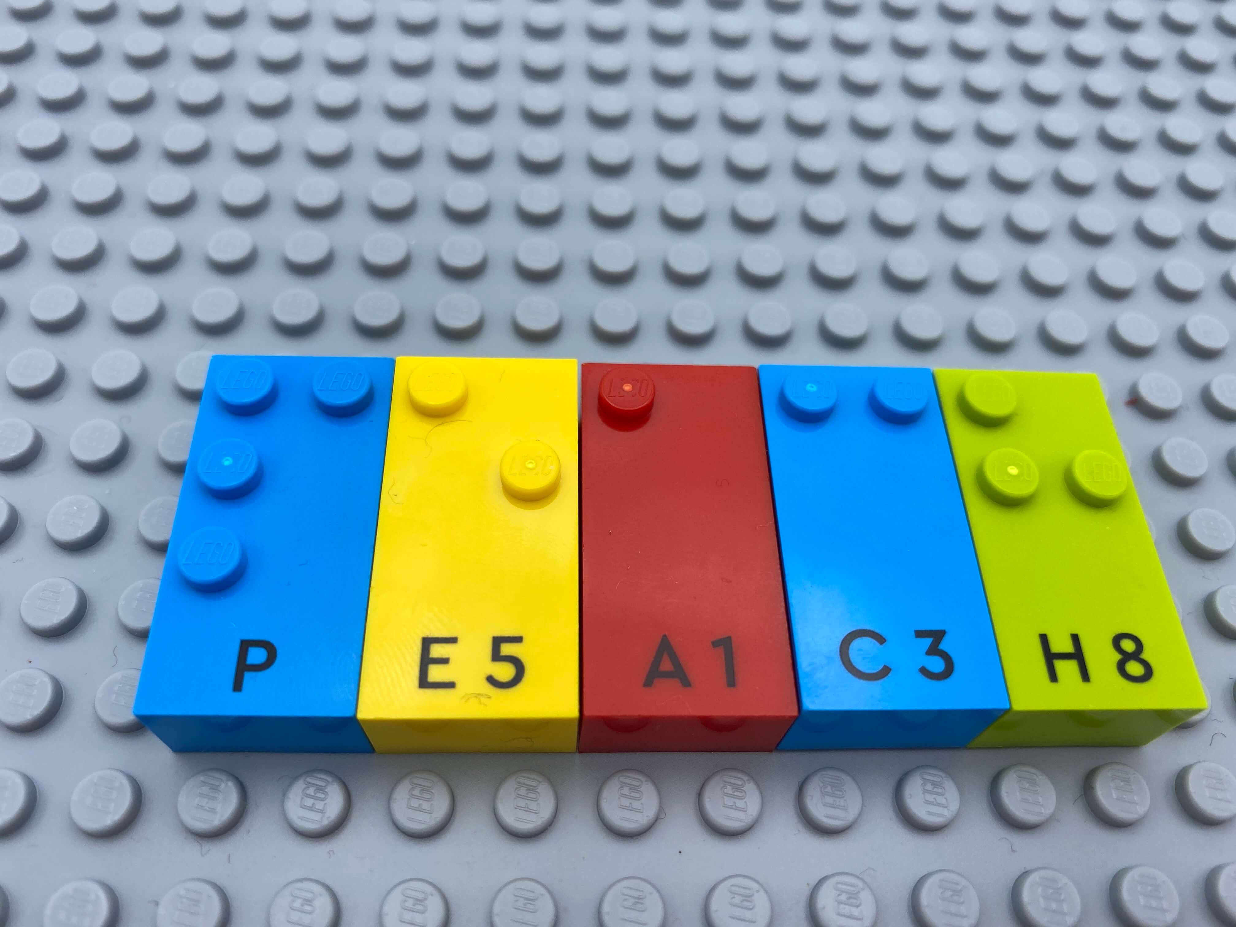 Letter bricks p, e, a, c, h (peach) aligned on the base plate.