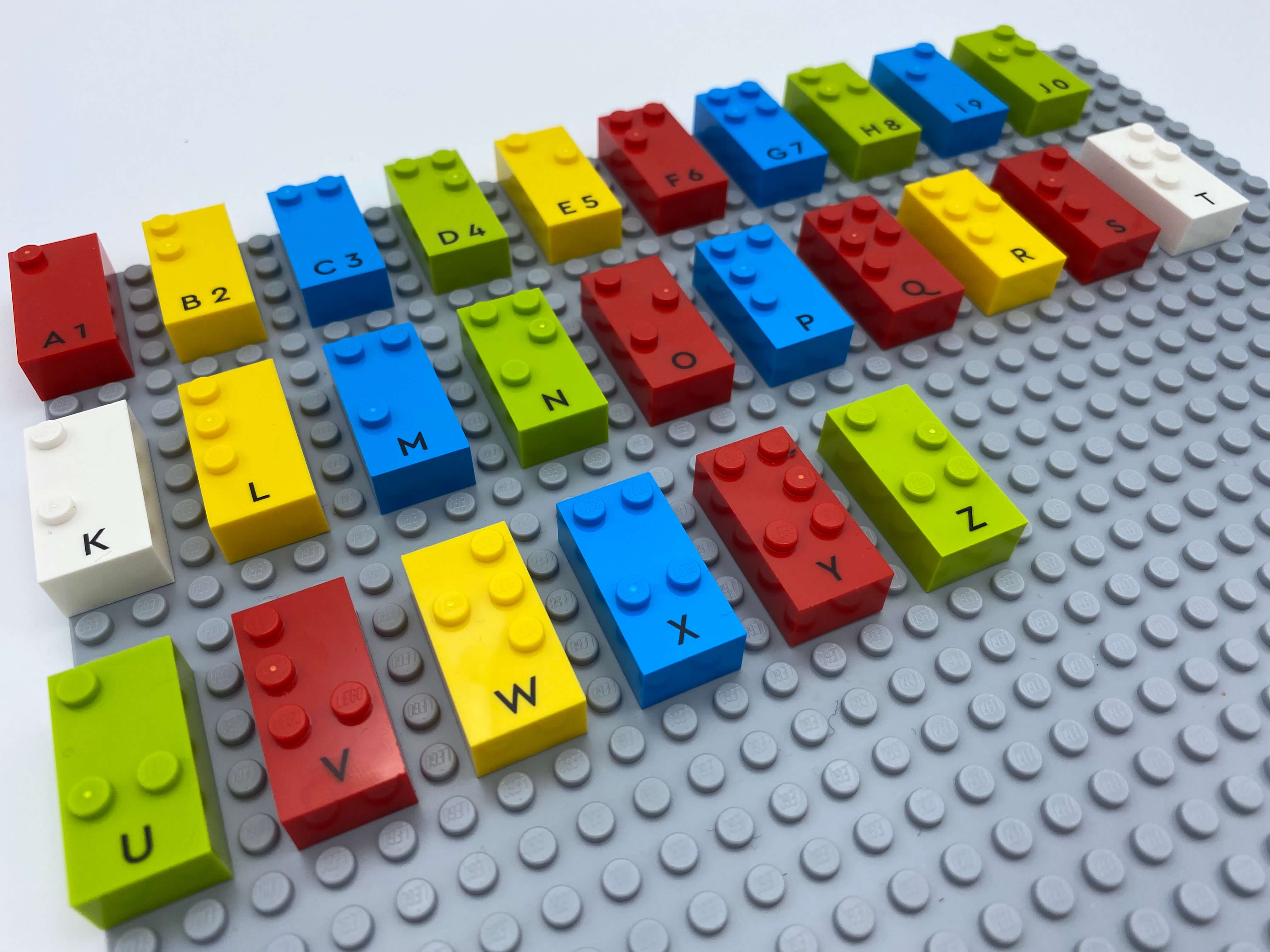 Letter bricks placed on the base plate, in alphabetical order.