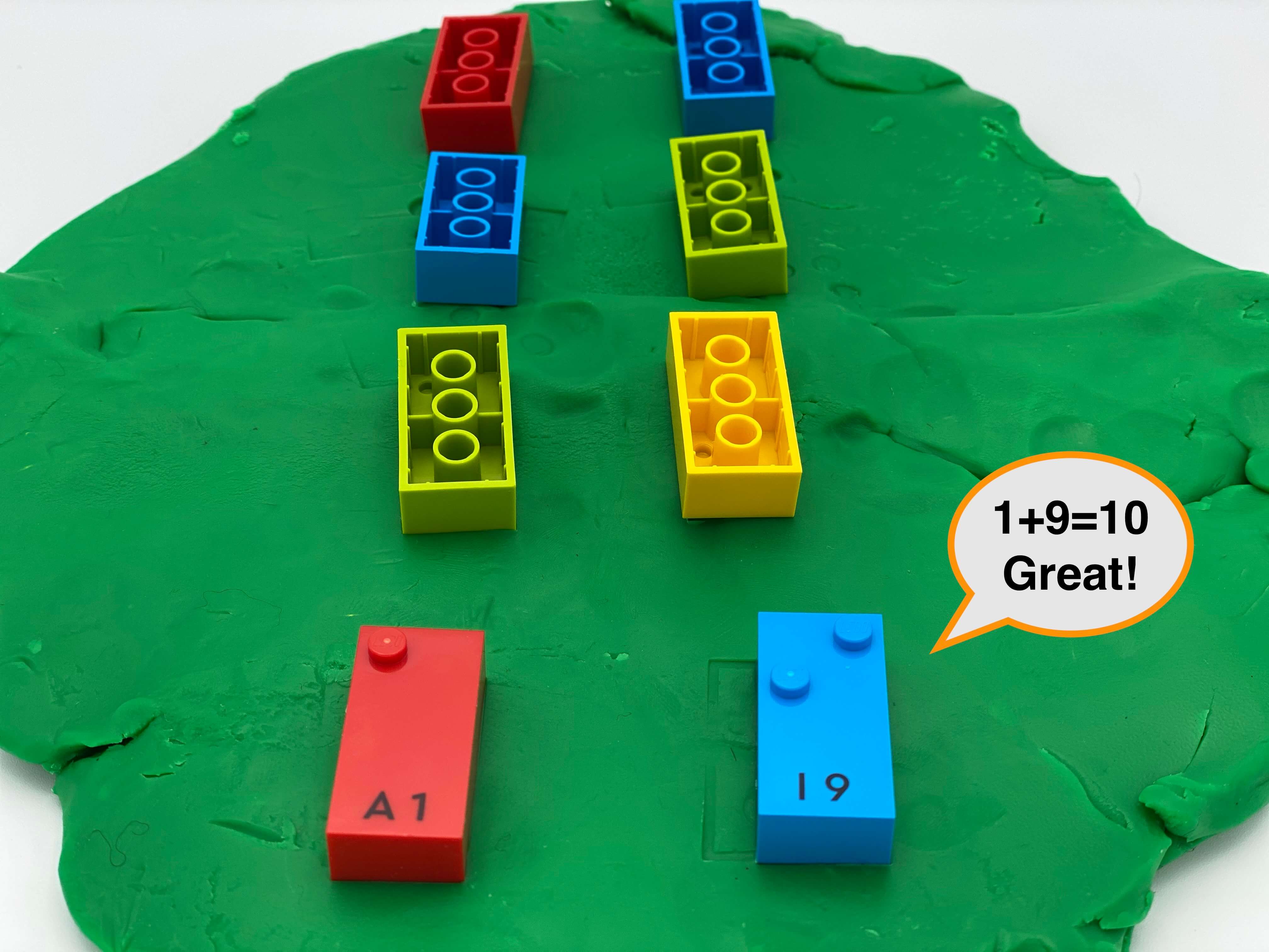 A disc of play dough with 8 bricks: 6 upside-down, 2 right-side up showing number 1 and 9.A speech bubble says 1+9=10 Great!.