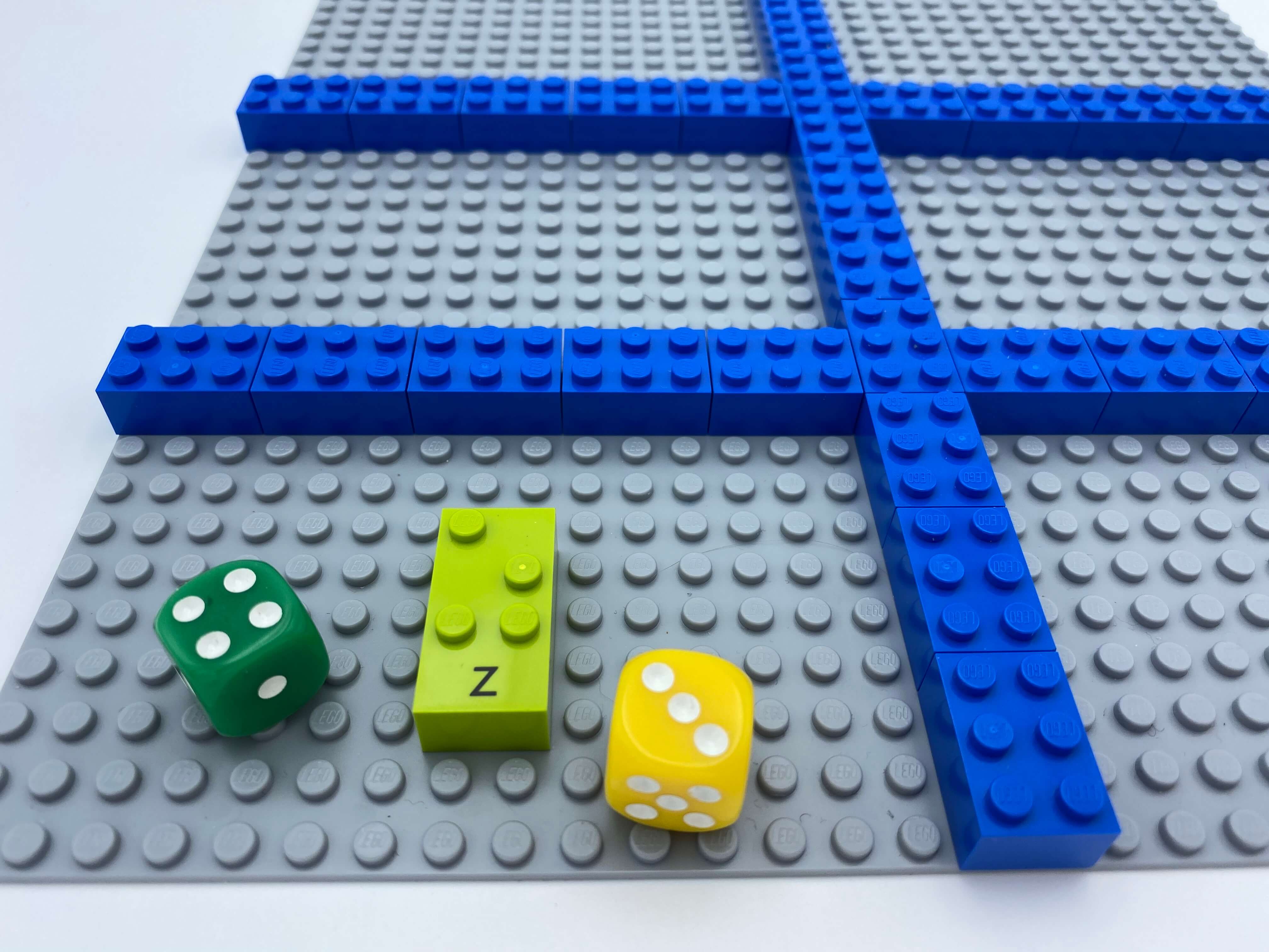 Sections made by classic LEGO bricks, 2 dice, 1 letter brick z on the base plate.