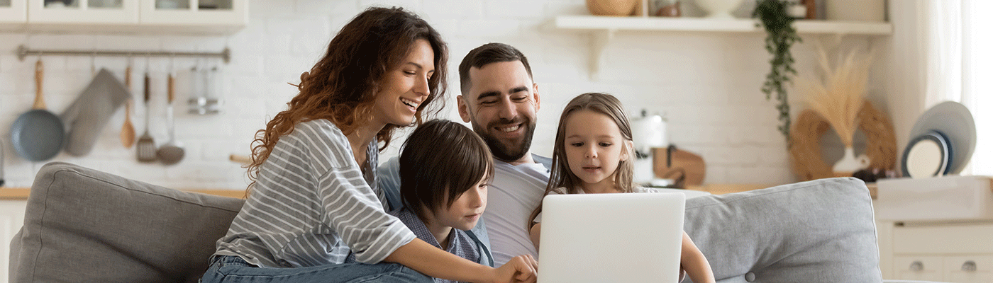 Picture of a family looking at a laptop.