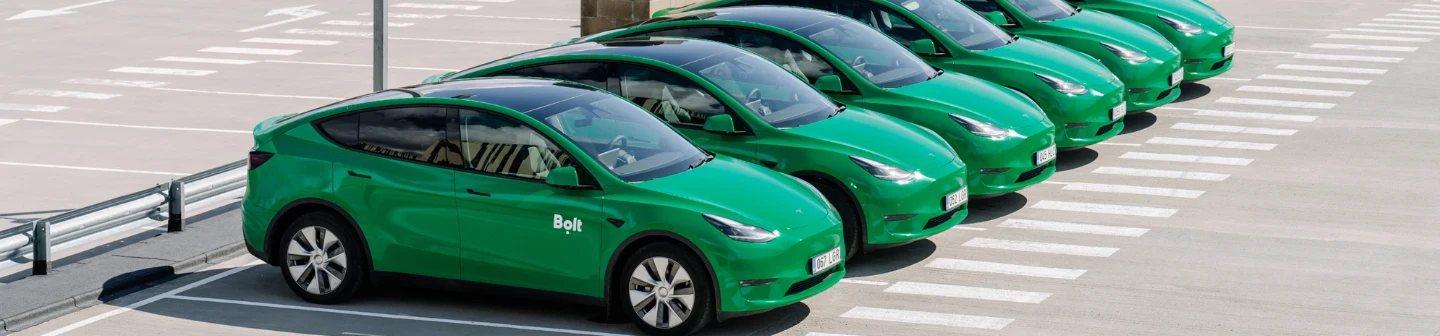 Fleet of Bolt-branded electric cars parked in rows, part of a sustainable transport push in Saudi Arabia.