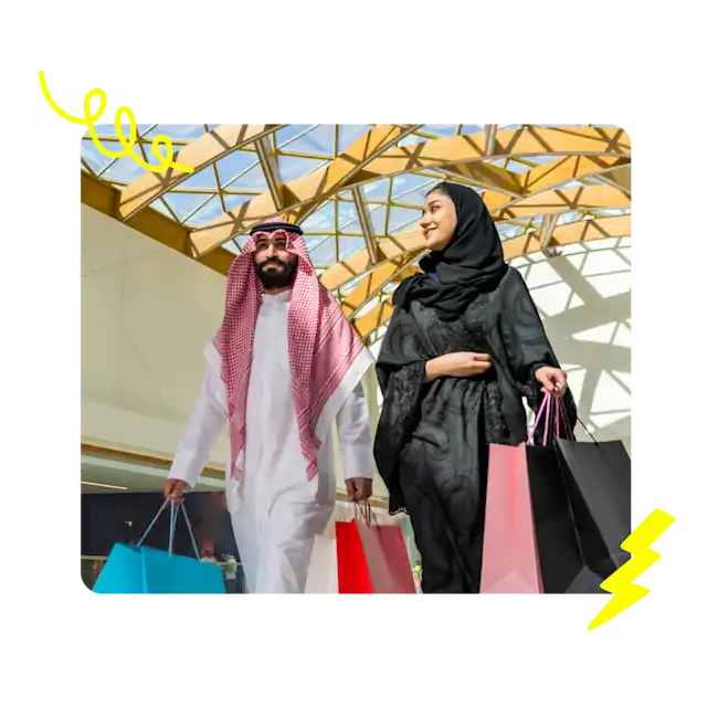 A couple carrying shopping bags.