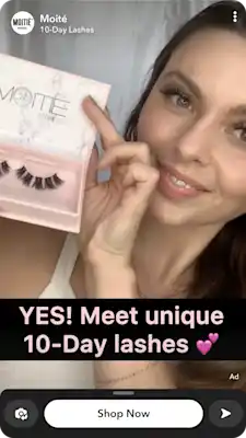Beauty creator holding eyelash product packaging in a Snapchat ecommerce ad promoting online sales.