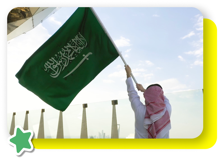 Person waving the Saudi national flag