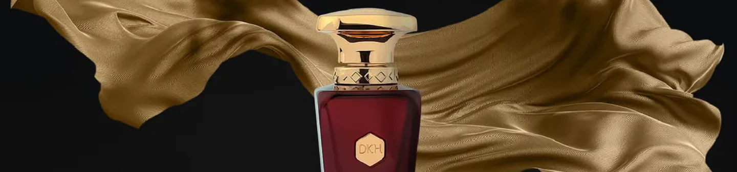 DKHOUN product image featuring a red and gold perfume bottle in front of flowing gold fabric on a black background.