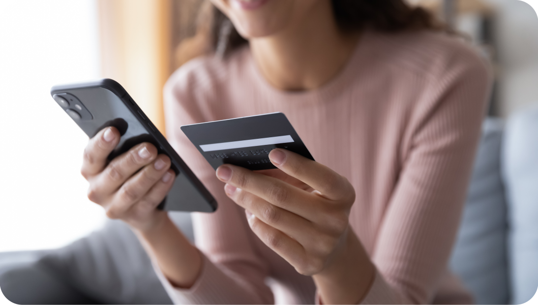 Woman adding her credit card number via her mobile phone