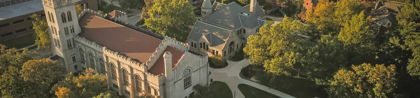 Bird’s eye view of Hope College’s exterior surrounded by trees as the sun is setting.