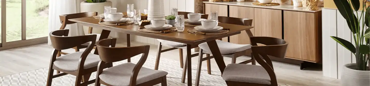 A modern dining room setup featuring a wooden table, cushioned chairs, and elegant tableware, complemented by warm-toned decor.