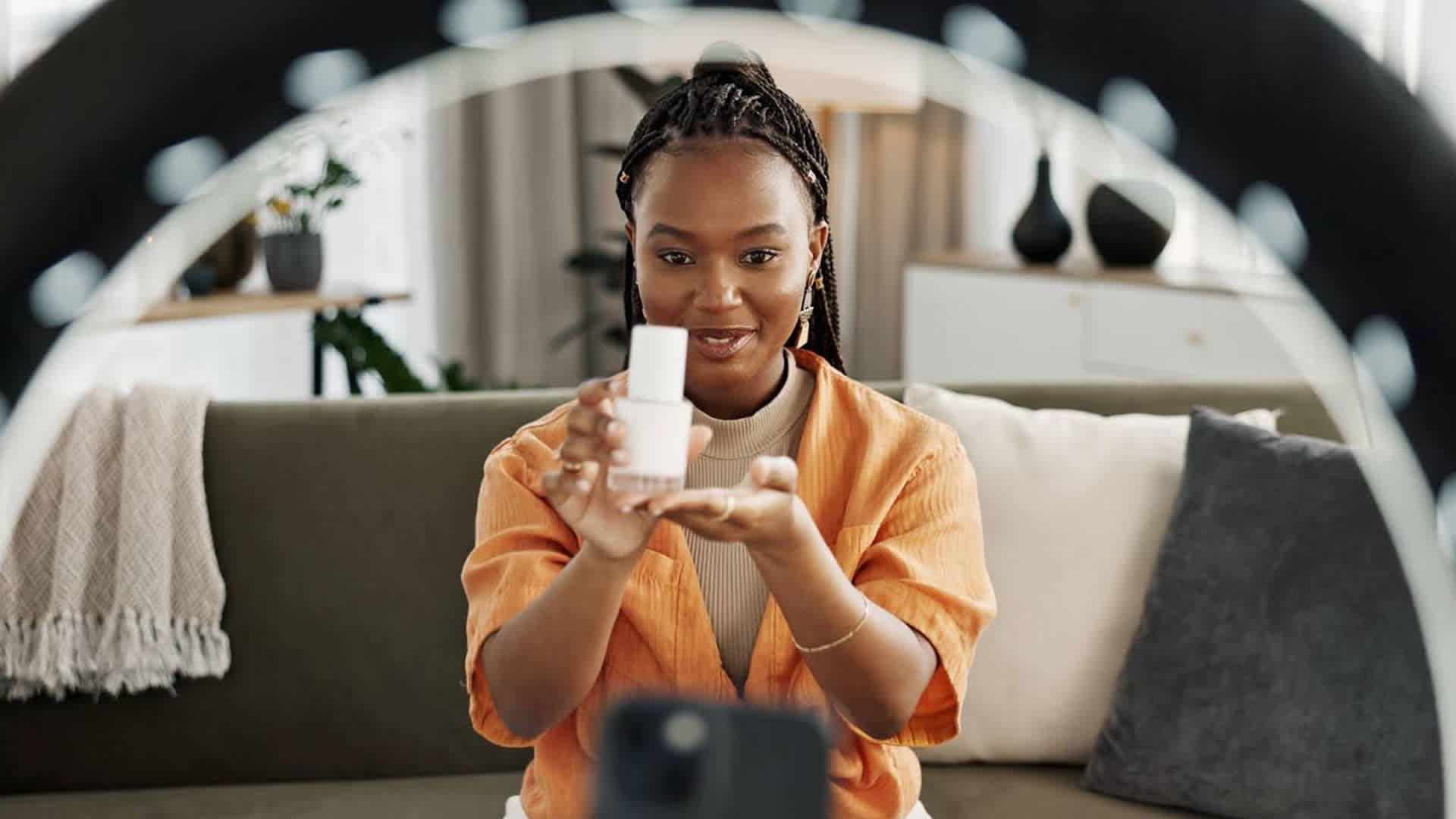Young creator reviewing a beauty product for a mobile video ad on Snapchat.