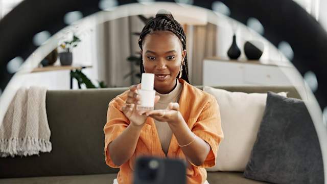 Young creator reviewing a beauty product for a mobile video ad on Snapchat.