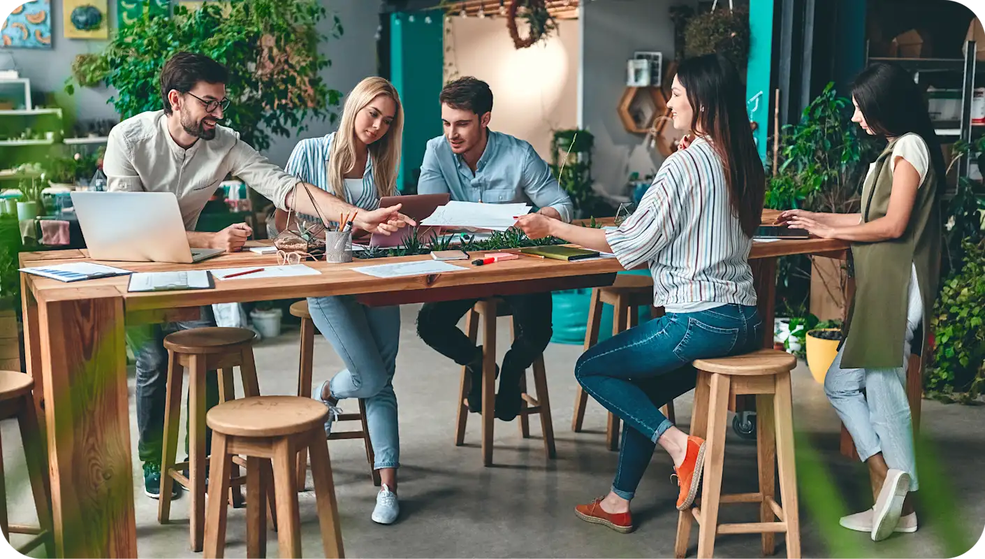A team of young people working together around a table