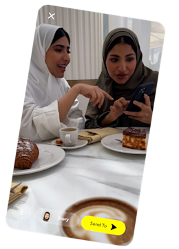 Two girls on their phone using Snapchat.