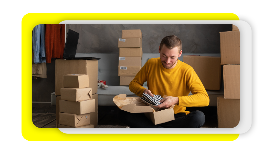 Man packaging products into a shipping box.