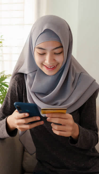 Woman smiling while adding her credit card number to her phone