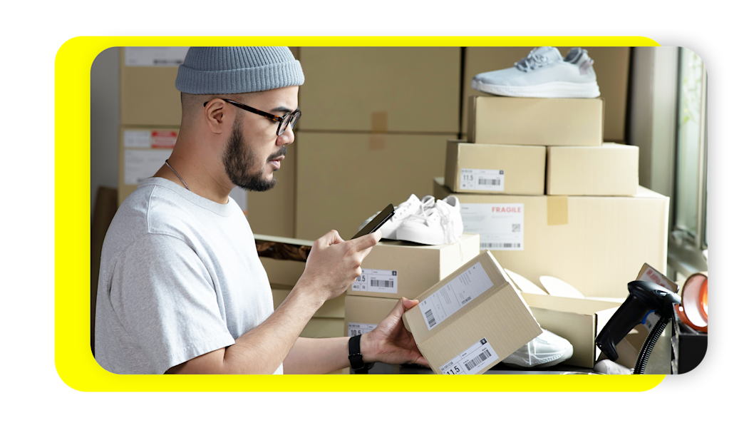 Man scanning inventory of shoes