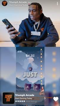A Snap Ad from Triumph Arcade featuring rapper Soulja Boy sitting on a couch playing a mobile game.