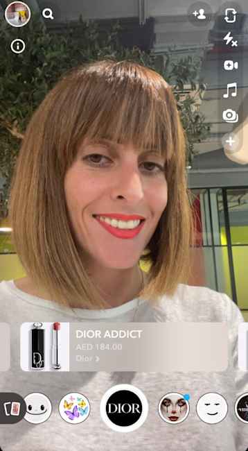 A close-up of a Christian Dior Addict lipstick swatch on a woman's lips powered by Snapchat's Shopping Lens