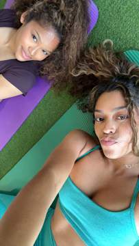Two Gen Z friends take Snapchat selfie in group fitness class to improve their health.