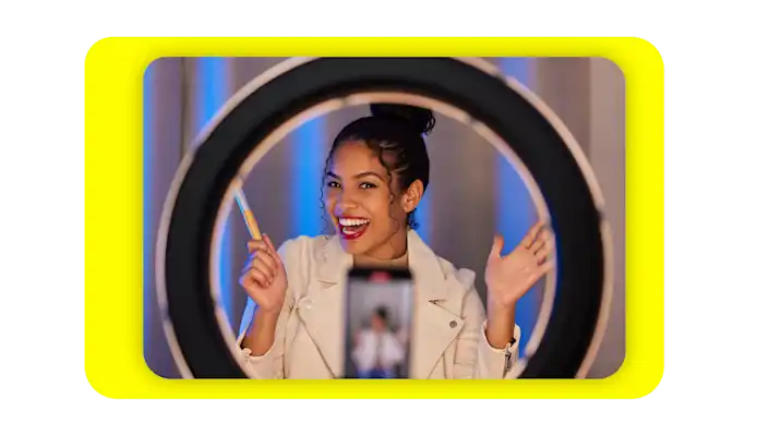 Image of a woman using a selfie light to record a video