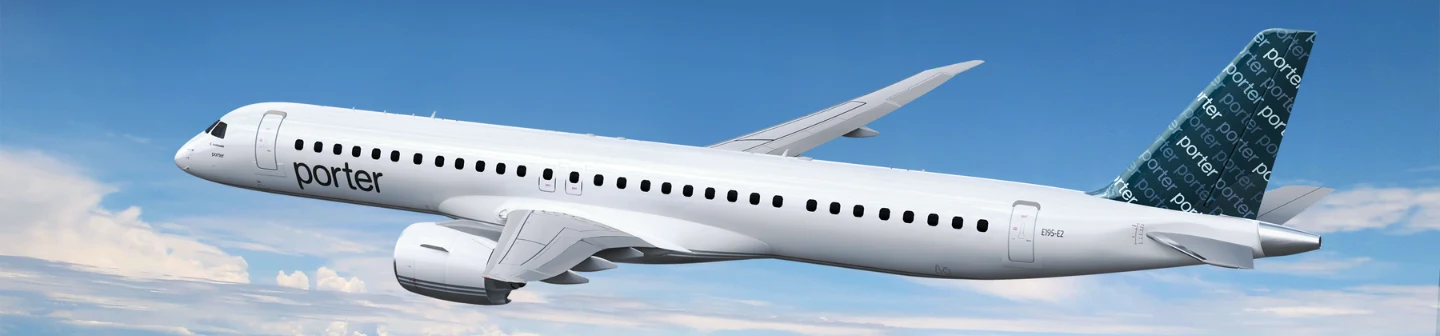 A Porter Airlines passenger jet with a patterned tail soars through a blue sky with light clouds.