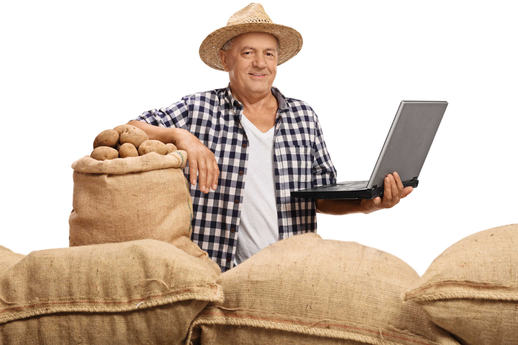 Mature farmer posing with pile of burlap sacks and laptop
