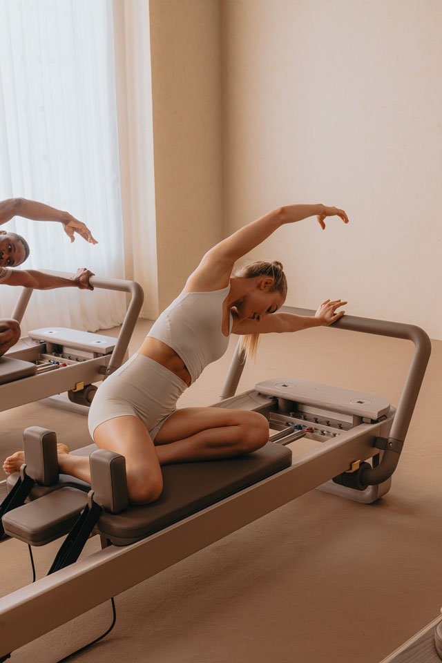 young-lady-training-on-a-technogym-pilates-reformer.jpg