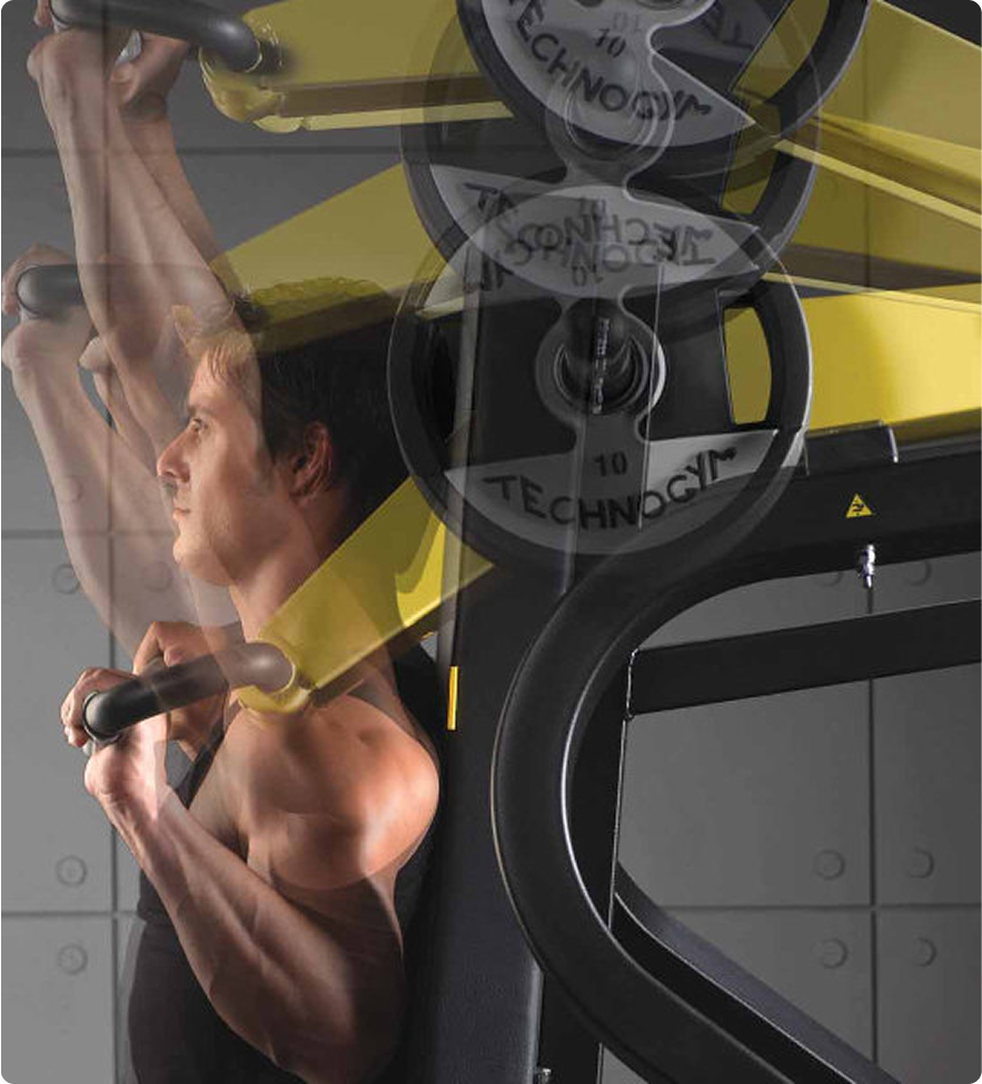 Man performing an overhead press on a shoulder press machine
