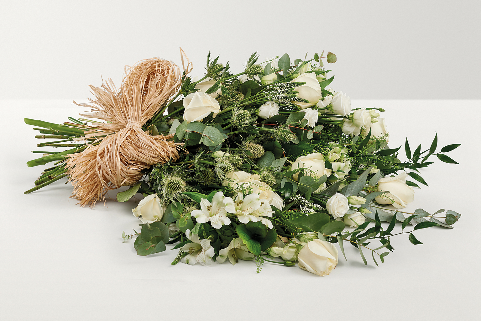 Large display of flowers with hand-tied bow
