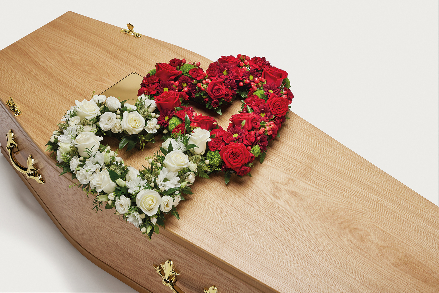 Red and white double heart shaped display on coffin