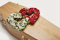 Red and white double heart shaped display on coffin