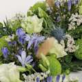 Zoomed in shot of blue and green wreath of flowers 