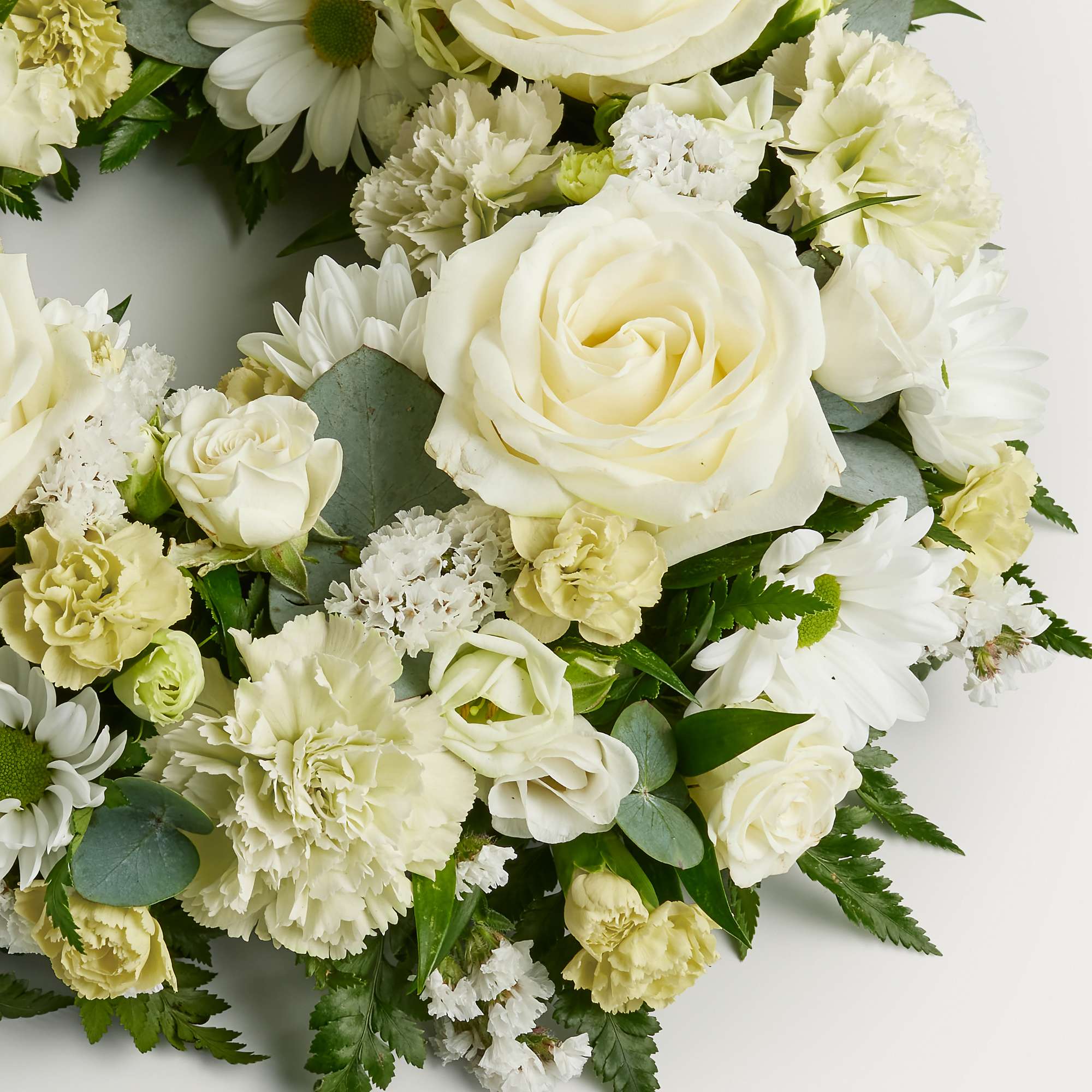 Zoomed in shot of white wreath of flowers 