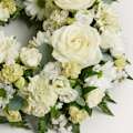Zoomed in shot of white wreath of flowers 