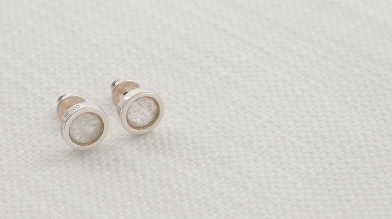 Silver stud earrings with white glass centres