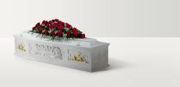 White coffin with a depiction of the last supper and large rose floral arrangement on top
