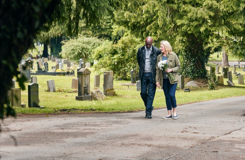 Couple walking in cemetery
