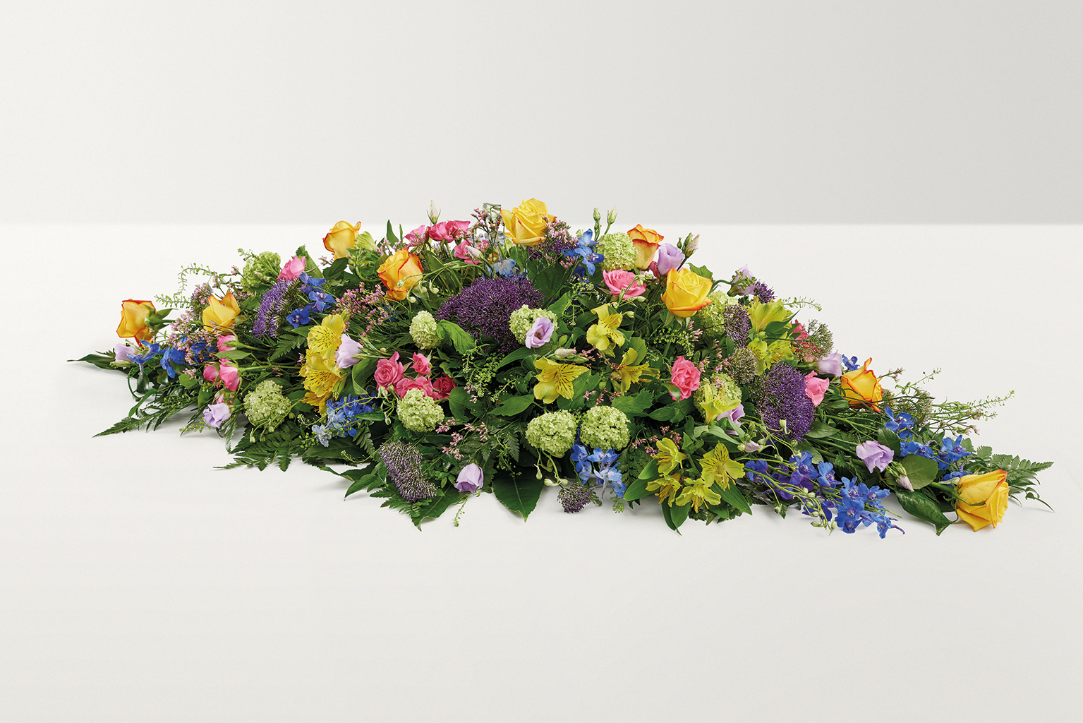 Bright coloured country mixed coffin spray 