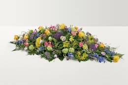 Bright coloured country mixed coffin spray 