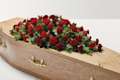 Red rose and carnation flowers on top of coffin