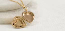Open heart shaped gold locket on a chain 