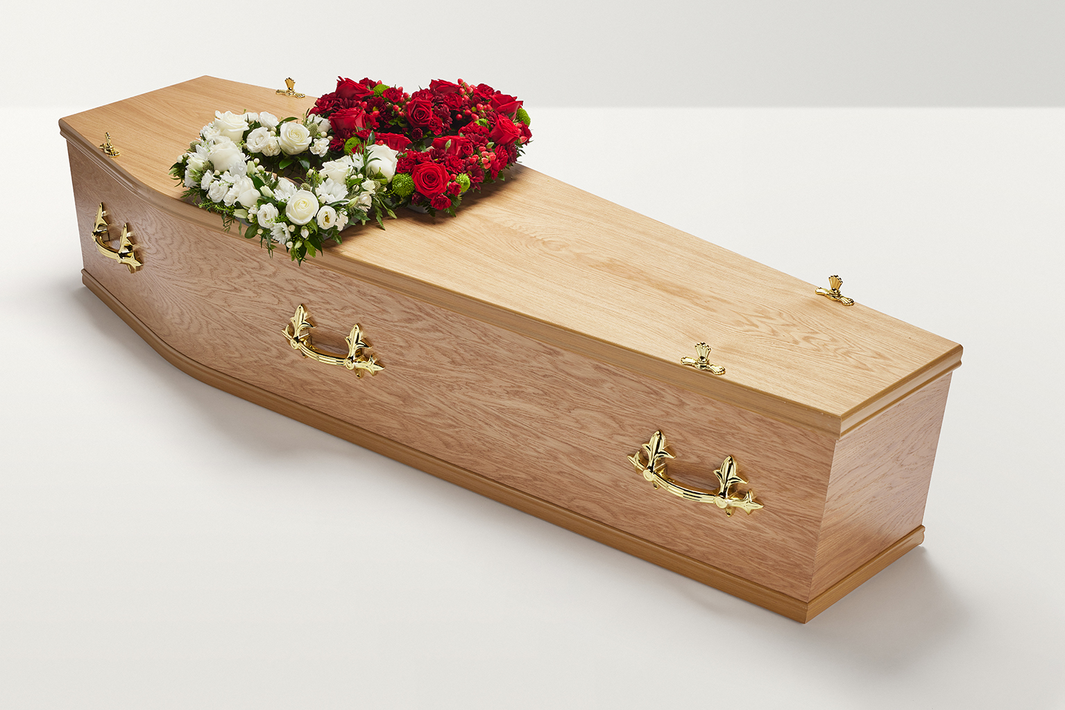 Zoomed out shot of red and white double heart shaped display on coffin