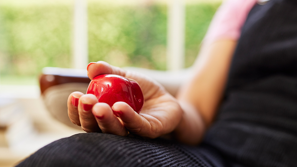 A woman holding a small memorial.